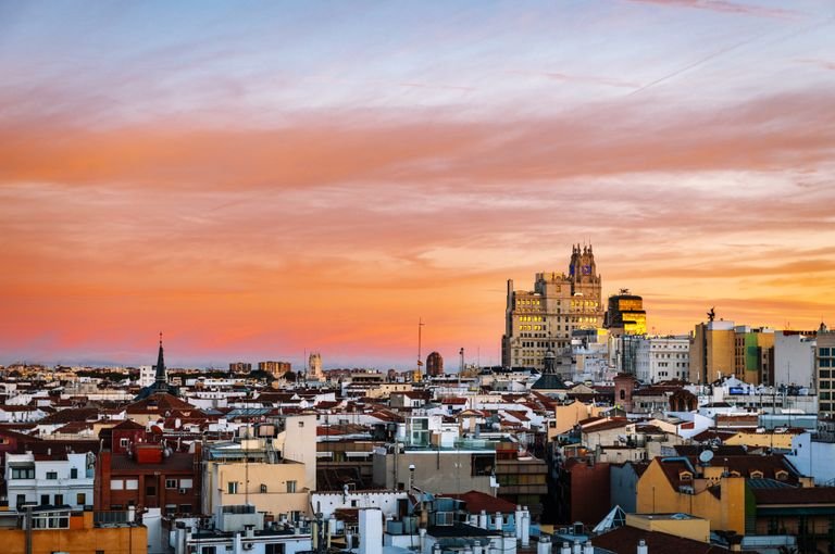 Breathtaking view of Madrid's skyline at sunset showcasing iconic architecture and vibrant sky.