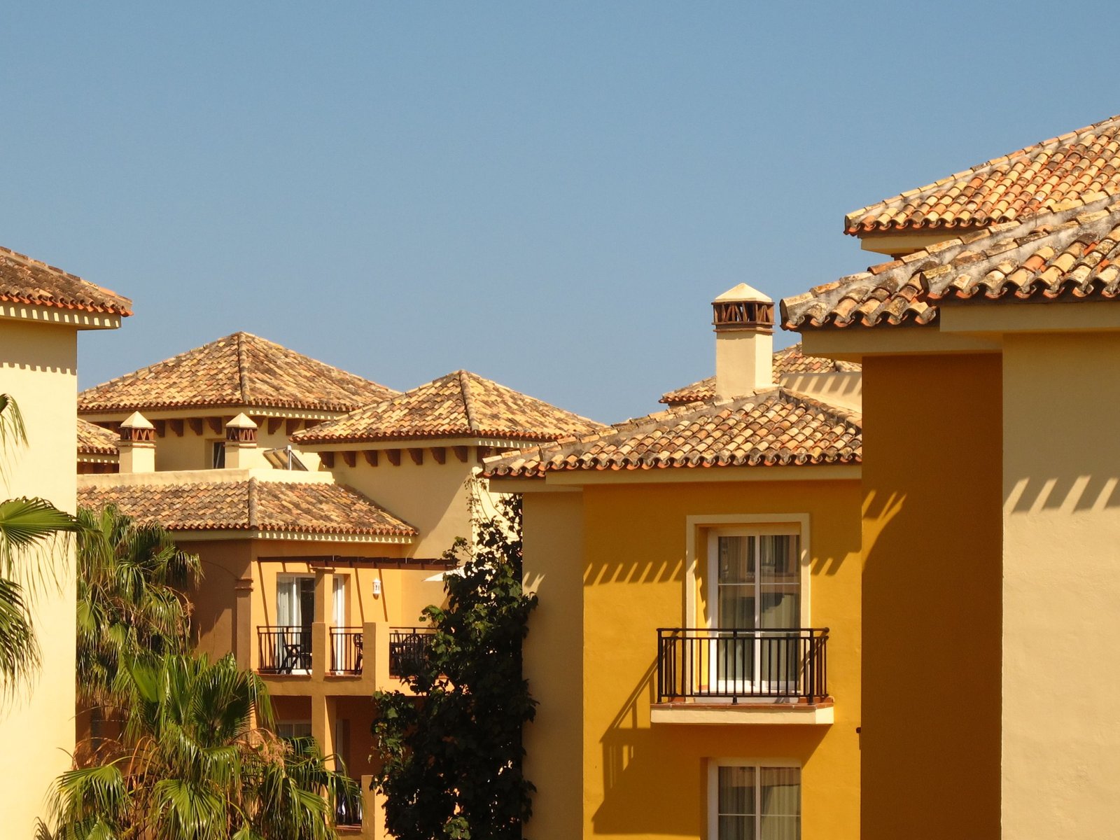 Charming yellow houses with gable roofs under the Andalusian sun in Marbella, Spain.